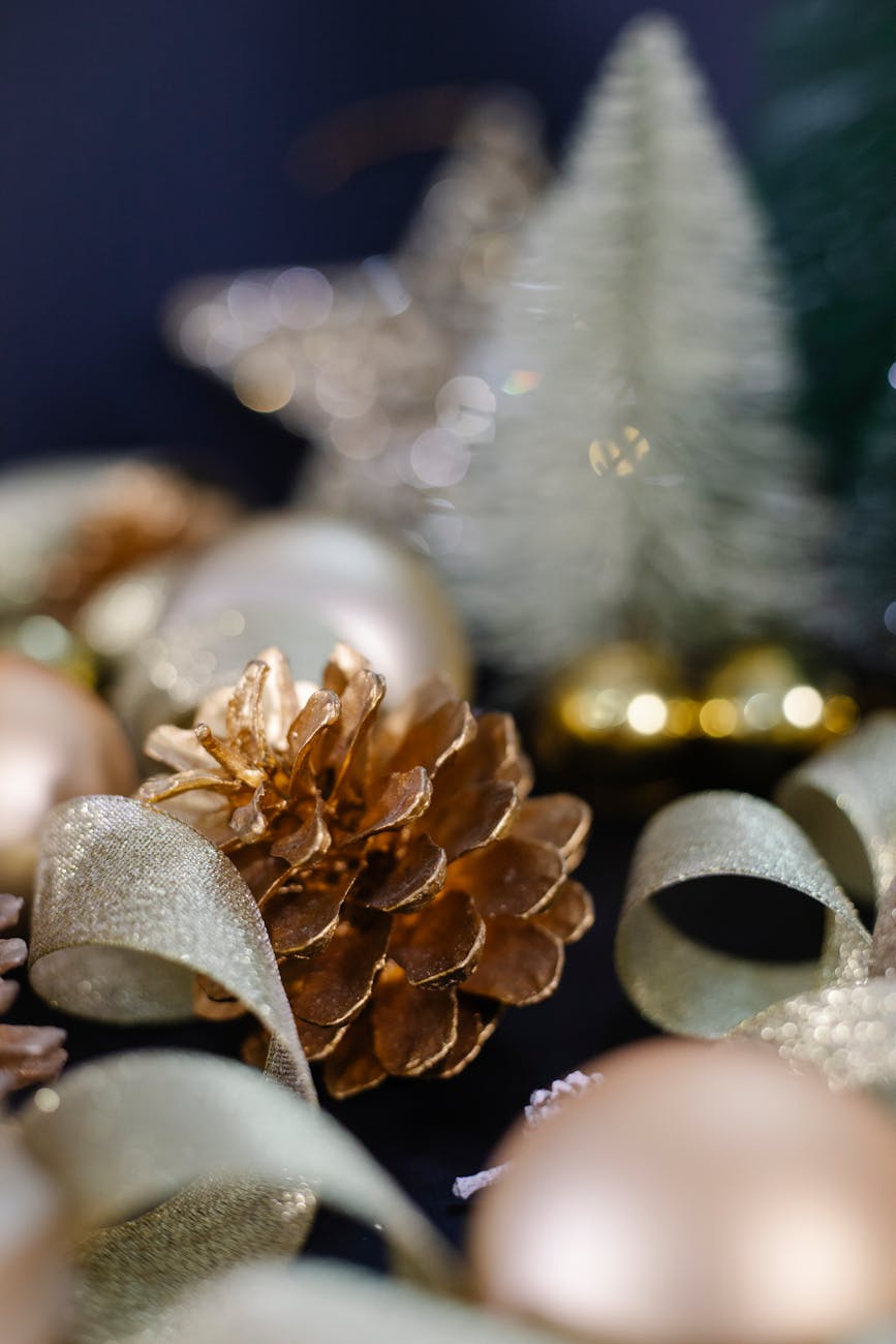 Festive Christmas scene with golden pinecones and ribbons, perfect for holiday decor.