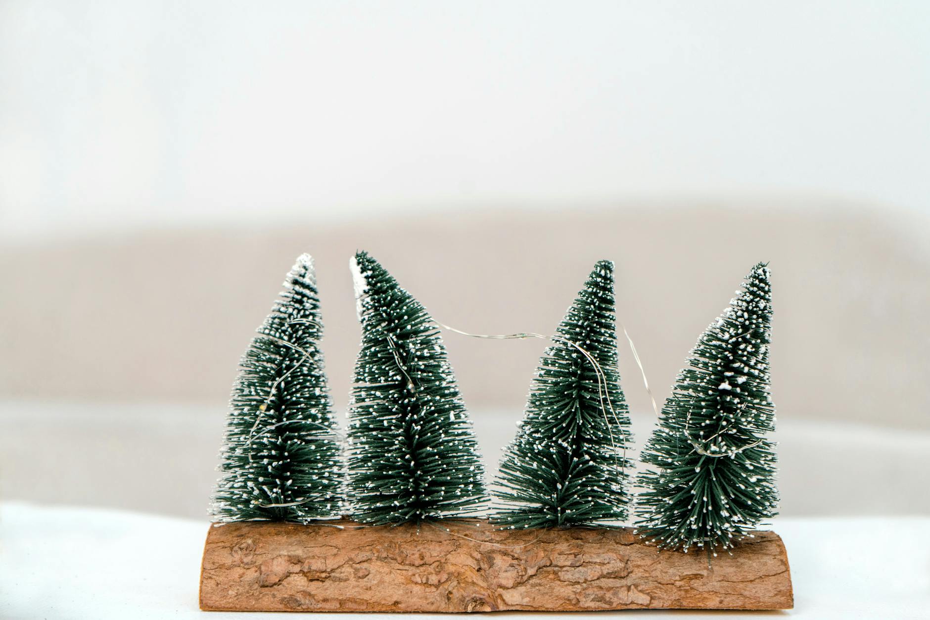 Handmade miniature Christmas trees on wood base, perfect for holiday decoration.