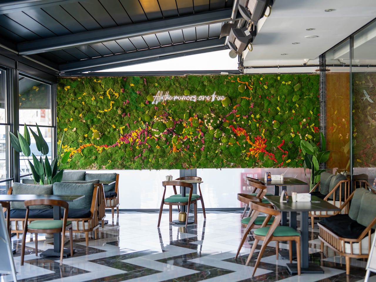 services-03 Cozy cafe interior in Kahramanmaraş with a vibrant living wall and modern decor.